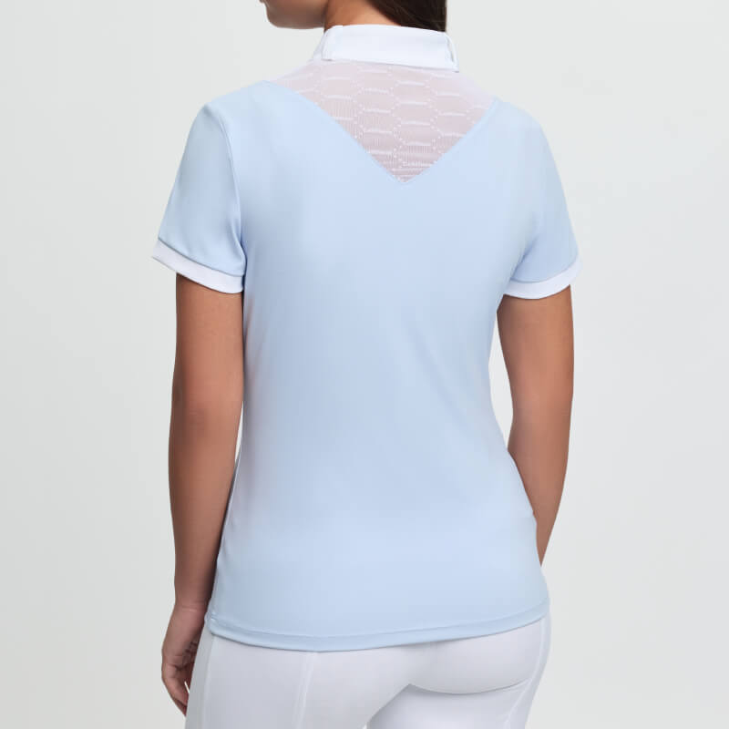 LeMieux Young Rider Eva Show Shirt Mist: woman in light blue polo with mesh V-back, facing away.
