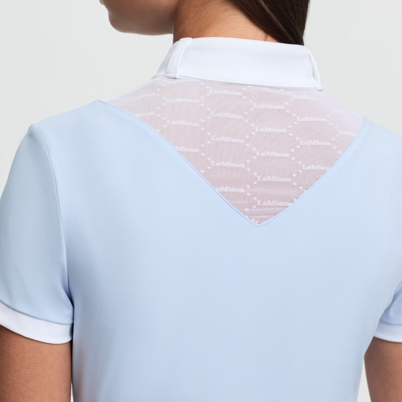 Woman in LeMieux Young Rider Eva Show Shirt Mist, mesh back, facing away.
