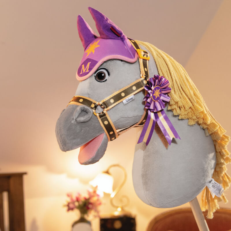 LeMieux Disney Hobby Horse Maximus—ideal for indoor fun with bridle, cap, ribbon, and yellow mane.