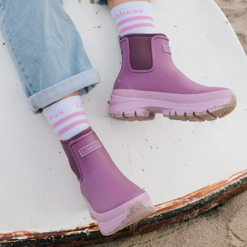 LeMieux Bramshaw Chelsea Welly Mallow boots with neoprene lining by the water, sunlight shining.