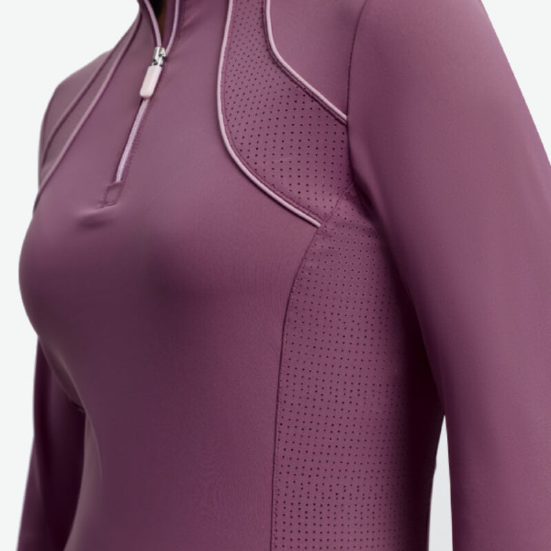 Person in a LeMieux Young Rider Airflow Baselayer Mallow with perforated panels for breathability.