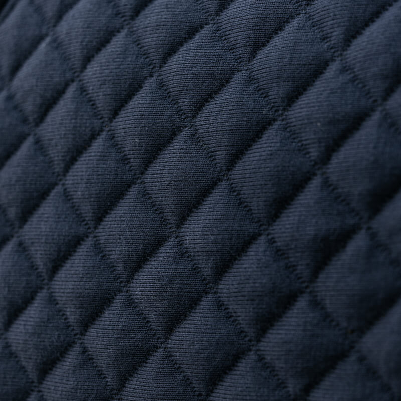 Close-up of quilted navy fabric with a diamond pattern from the LeMieux Arika Clima-Tek Rug.