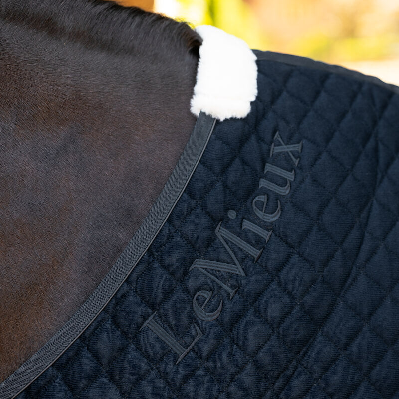 LeMieux Arika Clima-Tek Rug Navy with white sheepskin trim keeps your horse cool.