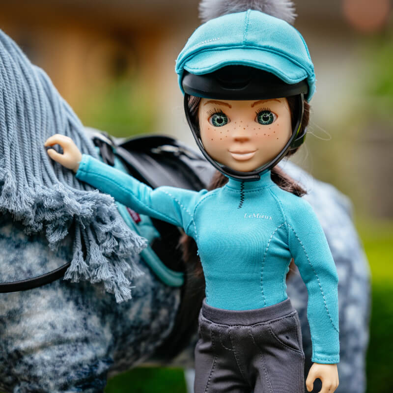 LeMieux Toy Rider Outfit Azure: teal hat, teal shirt, gray pants on a white background.
