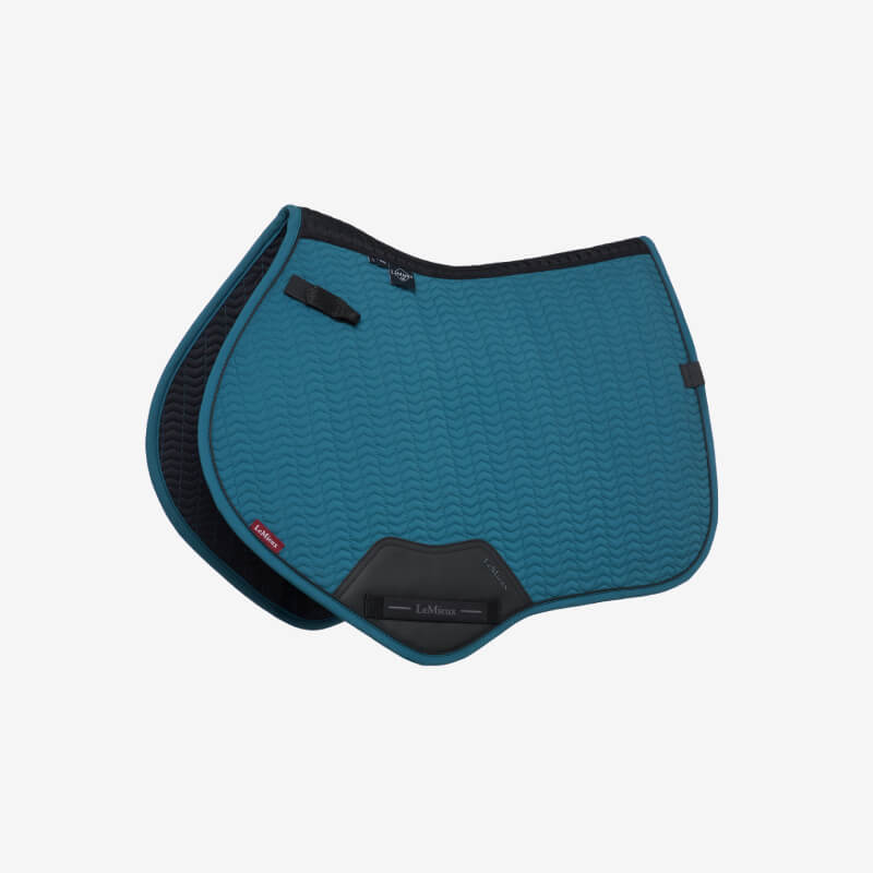 Brown saddle and black stirrup on LeMieux Essence Close Contact Square Jungle atop a horse outdoors.