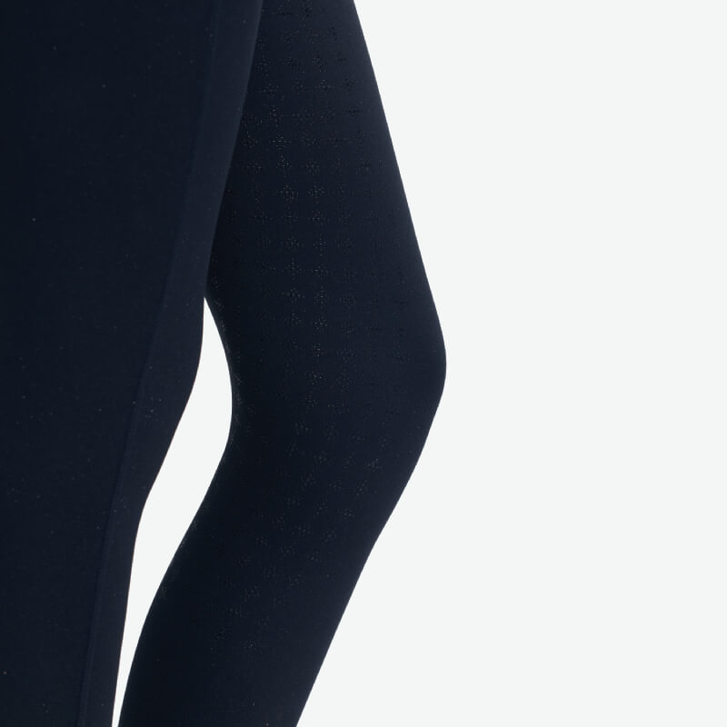 Close-up of person wearing LeMieux Young Rider Sparkle Orla Pull On Navy riding tights.
