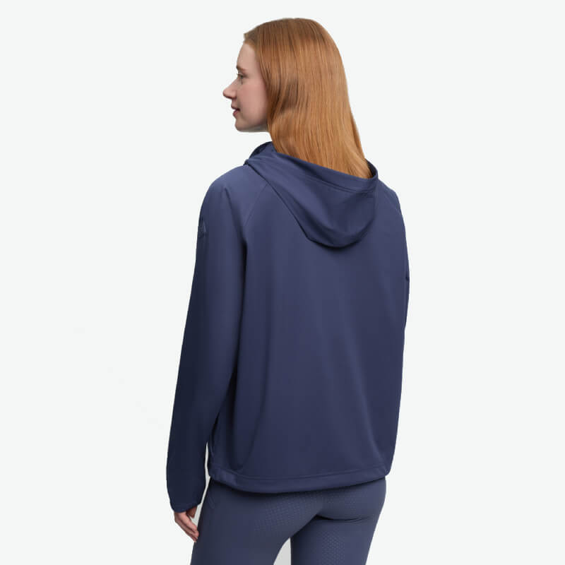 Woman with long hair in LeMieux Perri Half Zip Waterproof Hoodie Shadow, facing away.