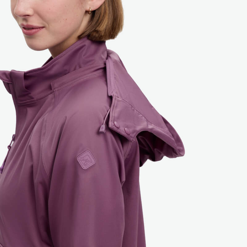 Woman in LeMieux Perri Half Zip Waterproof Hoodie Mallow, side view on white background.
