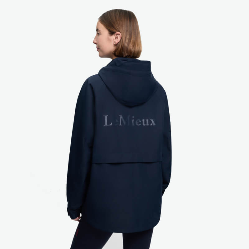 Woman wearing LeMieux Indra Waterproof Jacket Navy by LeMieux, against a white background.