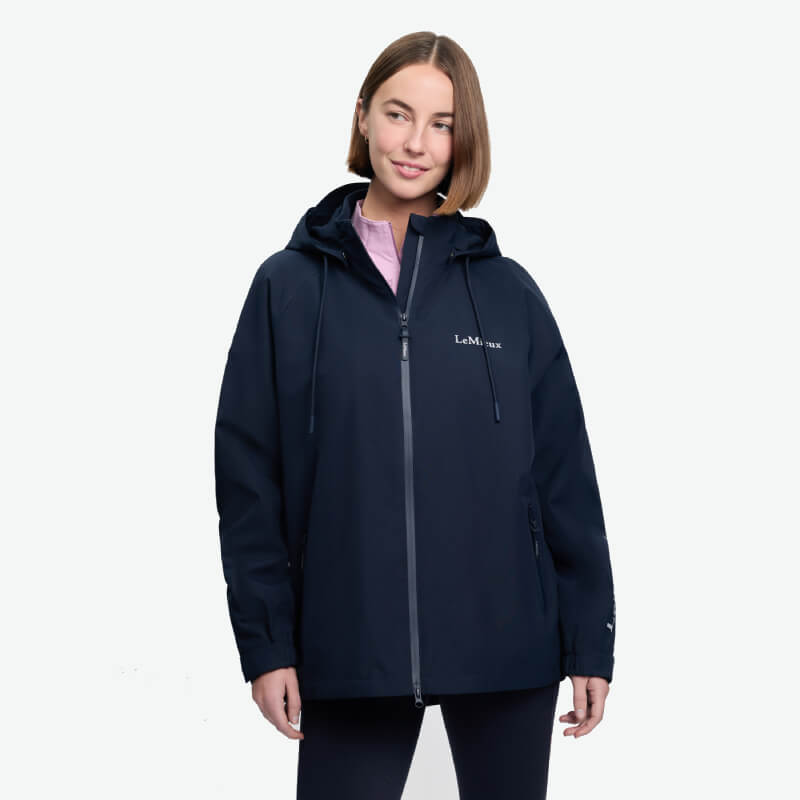 Woman wearing LeMieux Indra Waterproof Jacket Navy by LeMieux, against a white background.