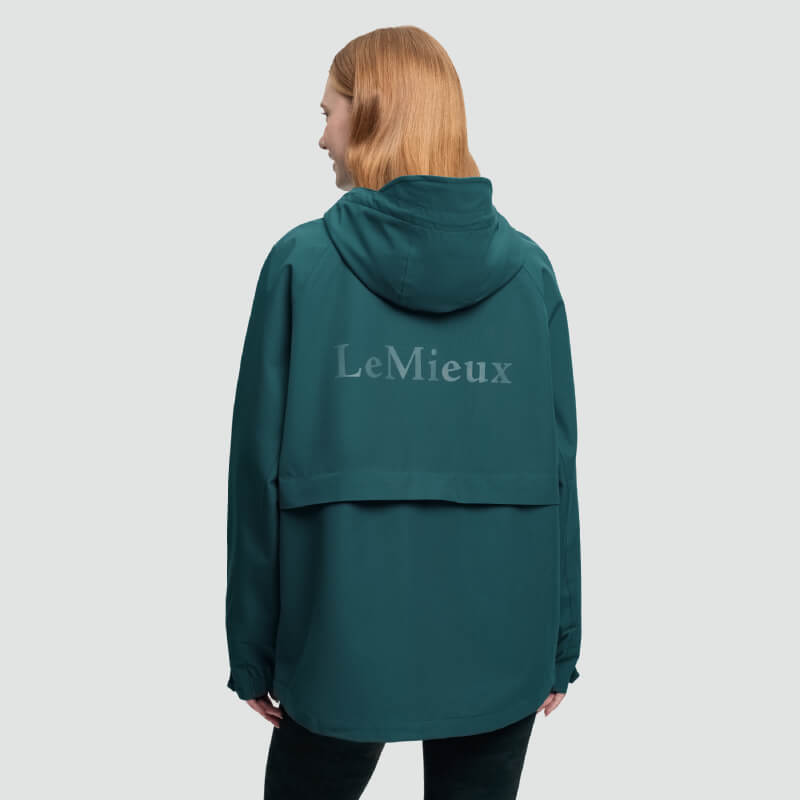 Person in a LeMieux Indra Waterproof Jacket Jungle, facing away from the camera.