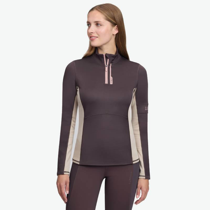 Woman in a LeMieux Matila Midlayer Cocoa, facing slightly left.