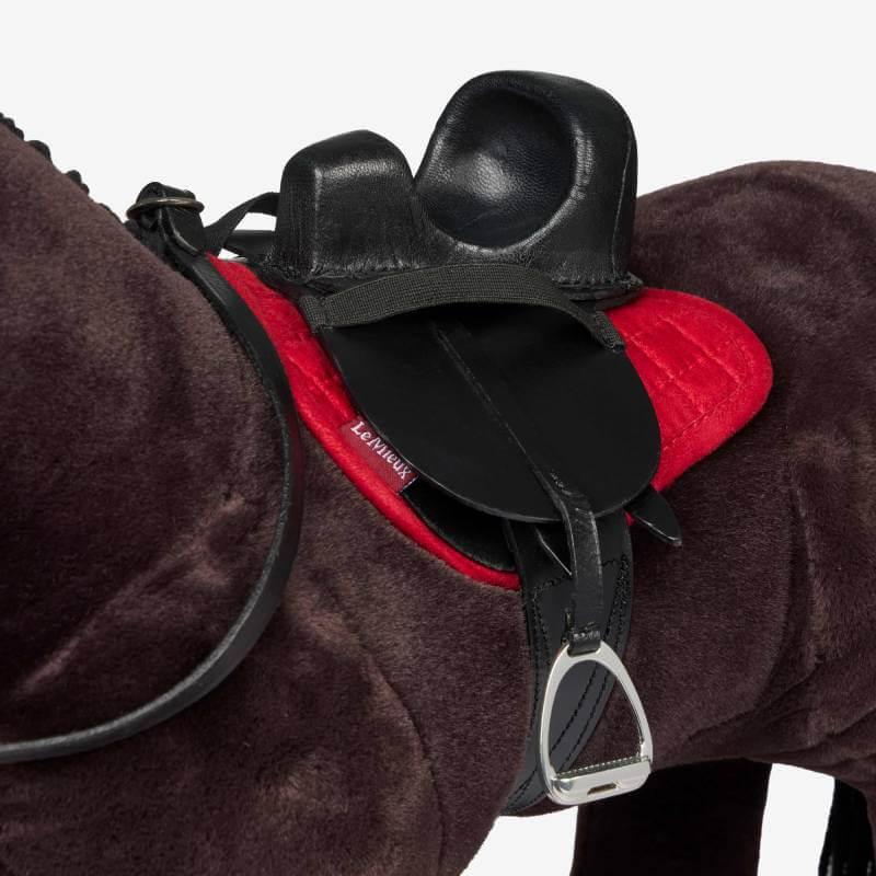 LeMieux Toy Rider Steady Saddle Black on a red pad, great for creative play.