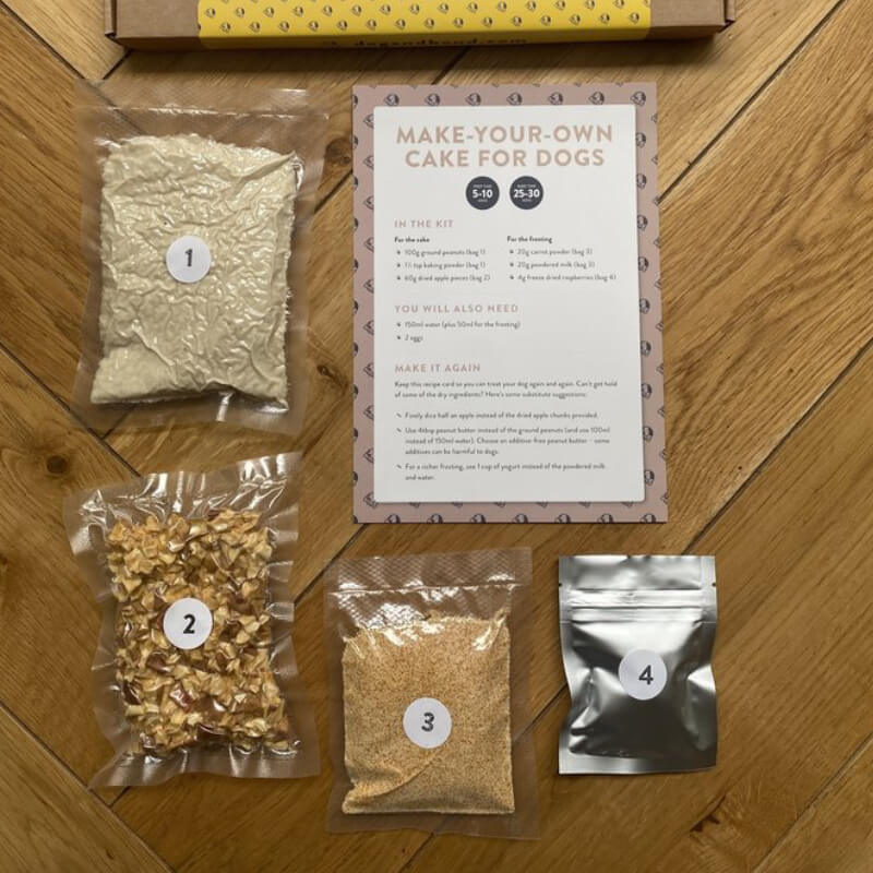 Brown box of Dog & Bond Dog Cake Mix, grain-free with branding and website details.