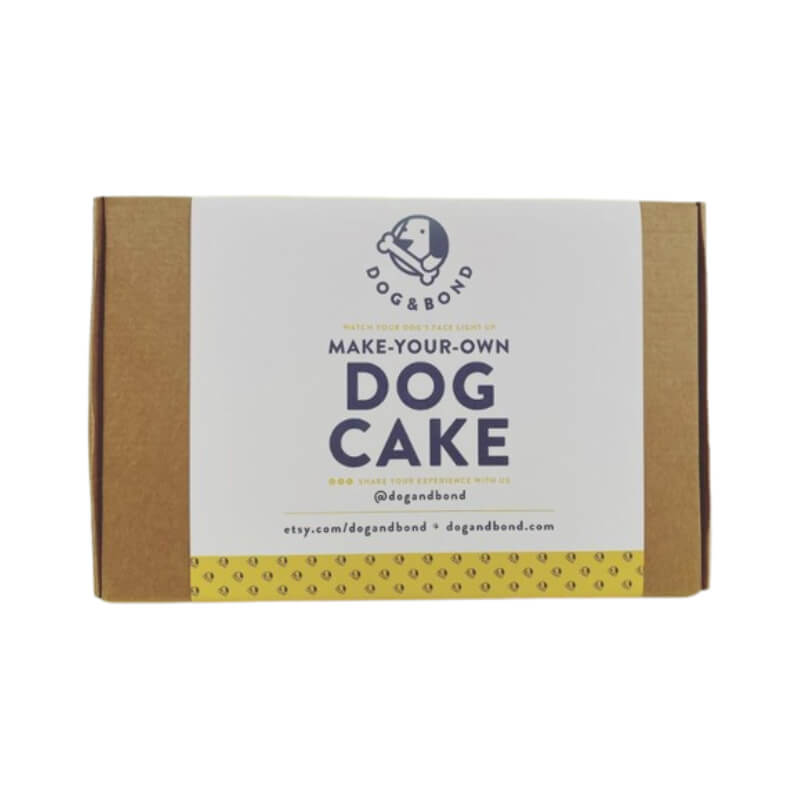 Brown box of Dog & Bond Dog Cake Mix, grain-free with branding and website details.