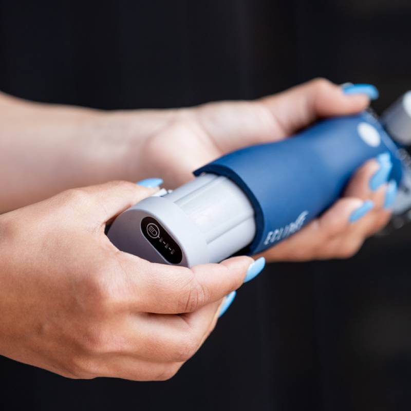 Hands hold a Lister Eclipse 2.0 Clippers Promo Kit by Lister with a white cartridge inside.