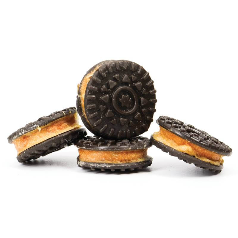 Four Deli Paws Cookies by Healthy Paws, stacked with chocolate tops and yellow filling.