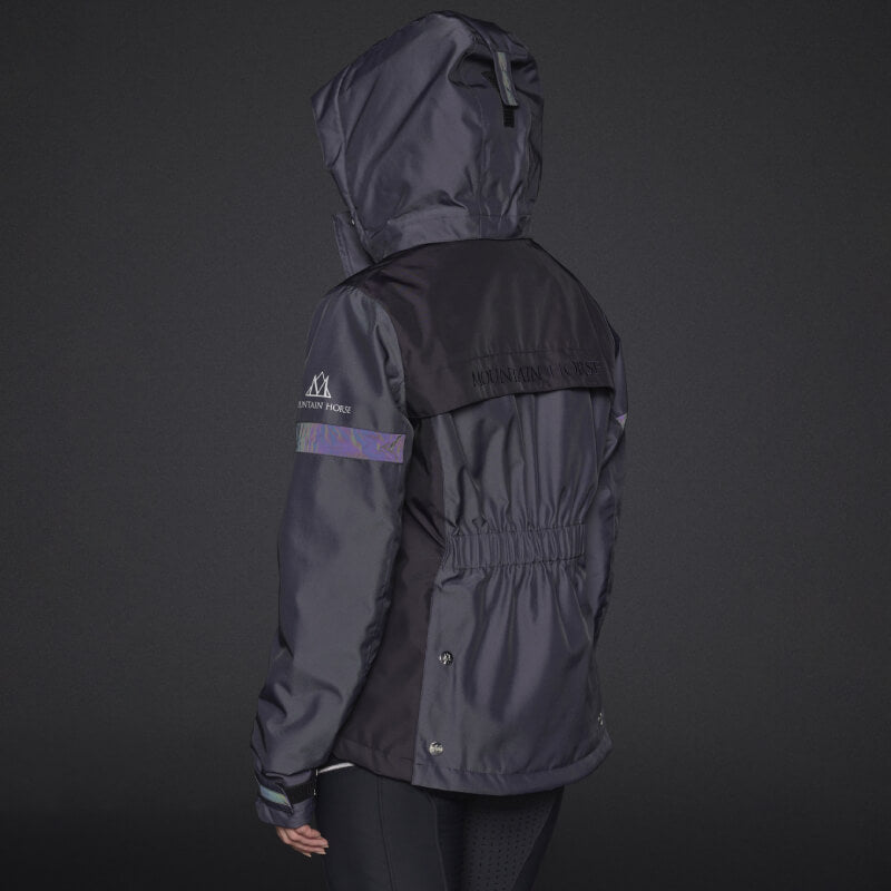 Person wearing the Mountain Horse Royal Grace Jacket in deep purple with reflective details.