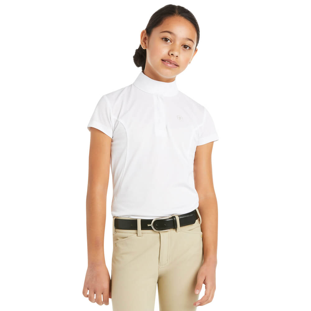 Young girl in an Ariat Youth Aptos SS Show Shirt White and beige pants, looking at the camera.