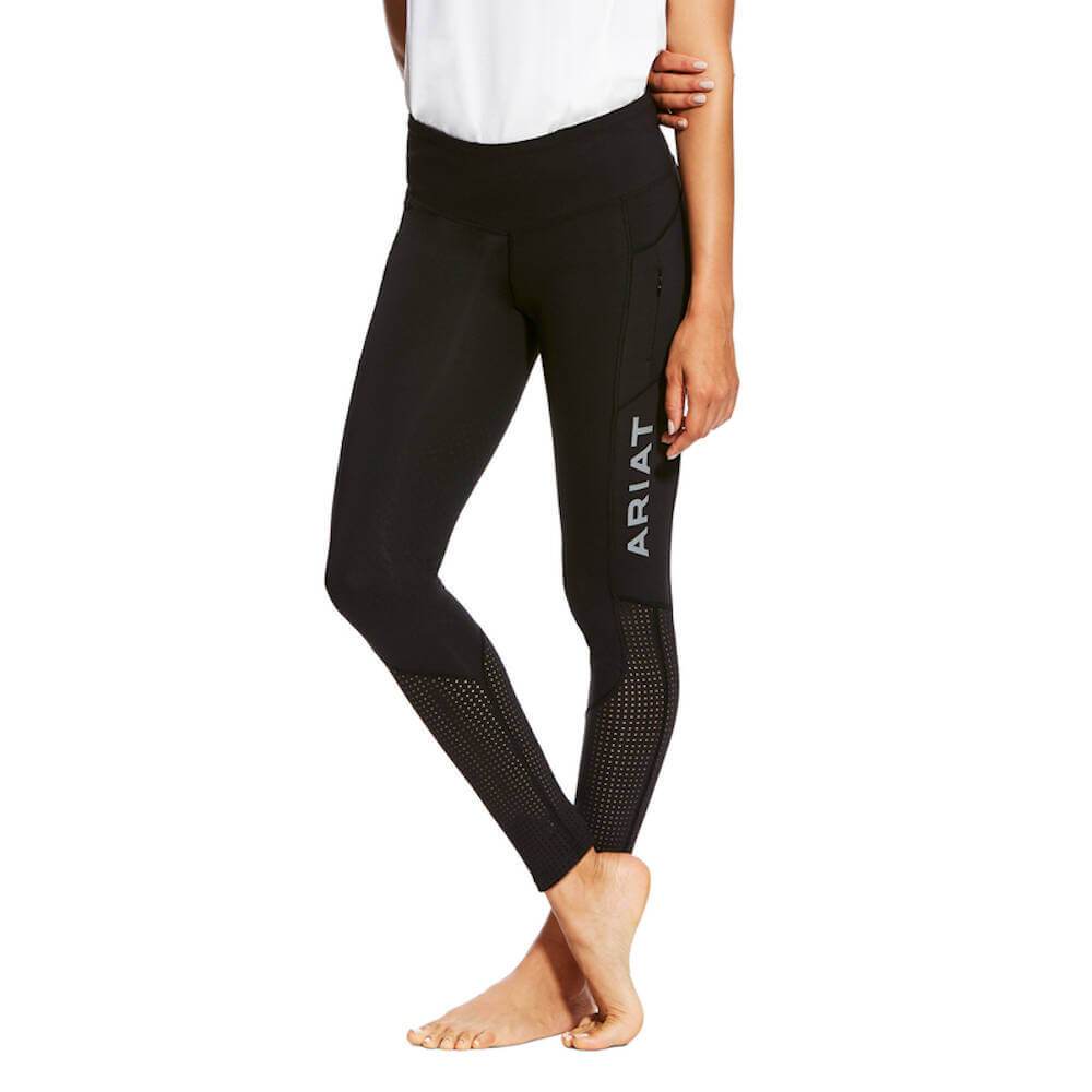 Wearing Ariat Womens Eos Knee Patch Tights in black with a white top, standing barefoot.