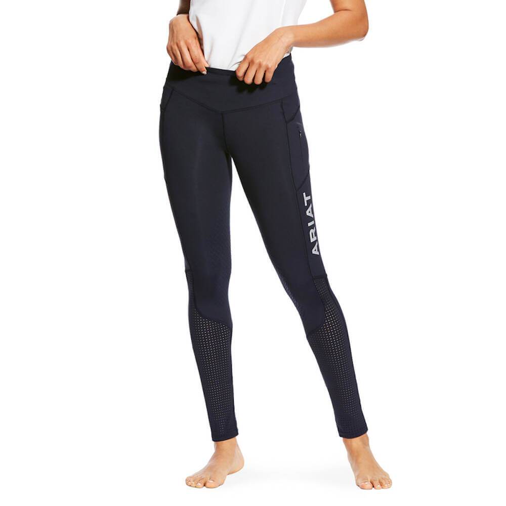 Woman in Ariat Womens Eos Knee Patch Tights Navy by Ariat, barefoot against a white background.