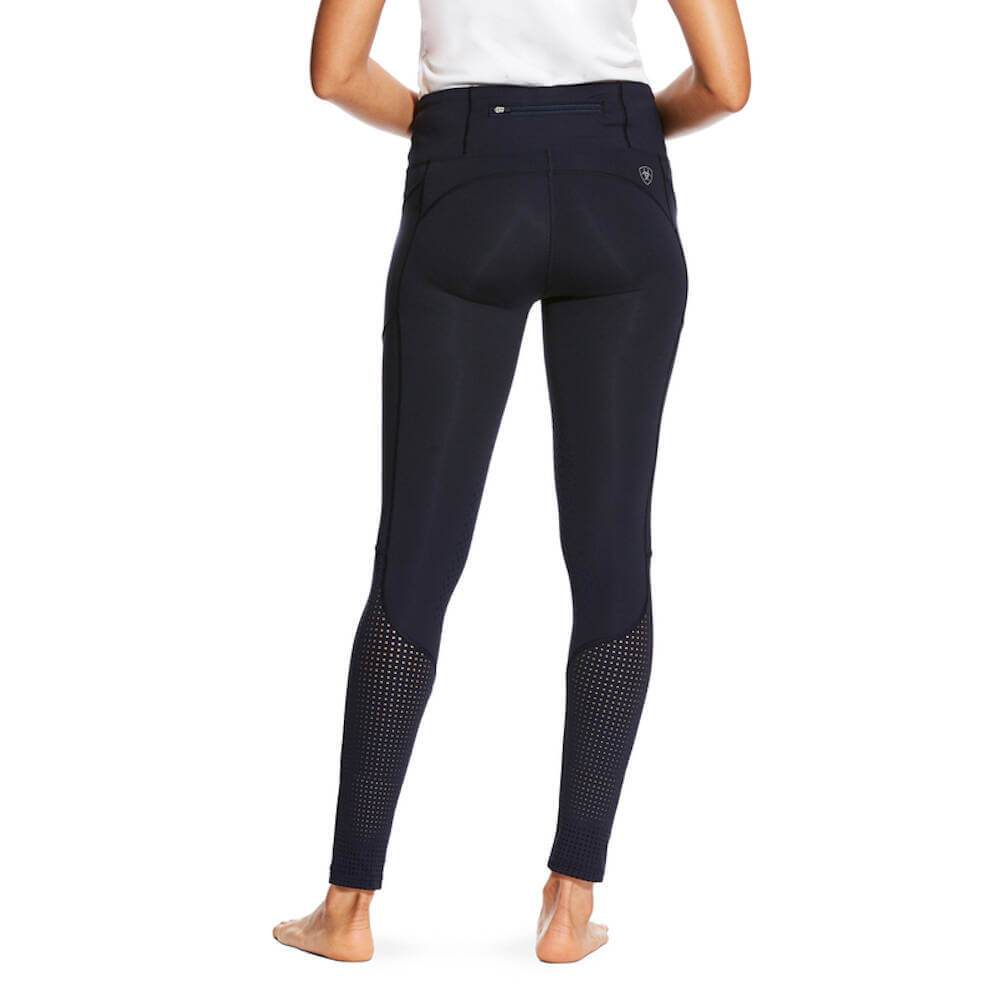 Woman in Ariat Womens Eos Knee Patch Tights Navy by Ariat, barefoot against a white background.