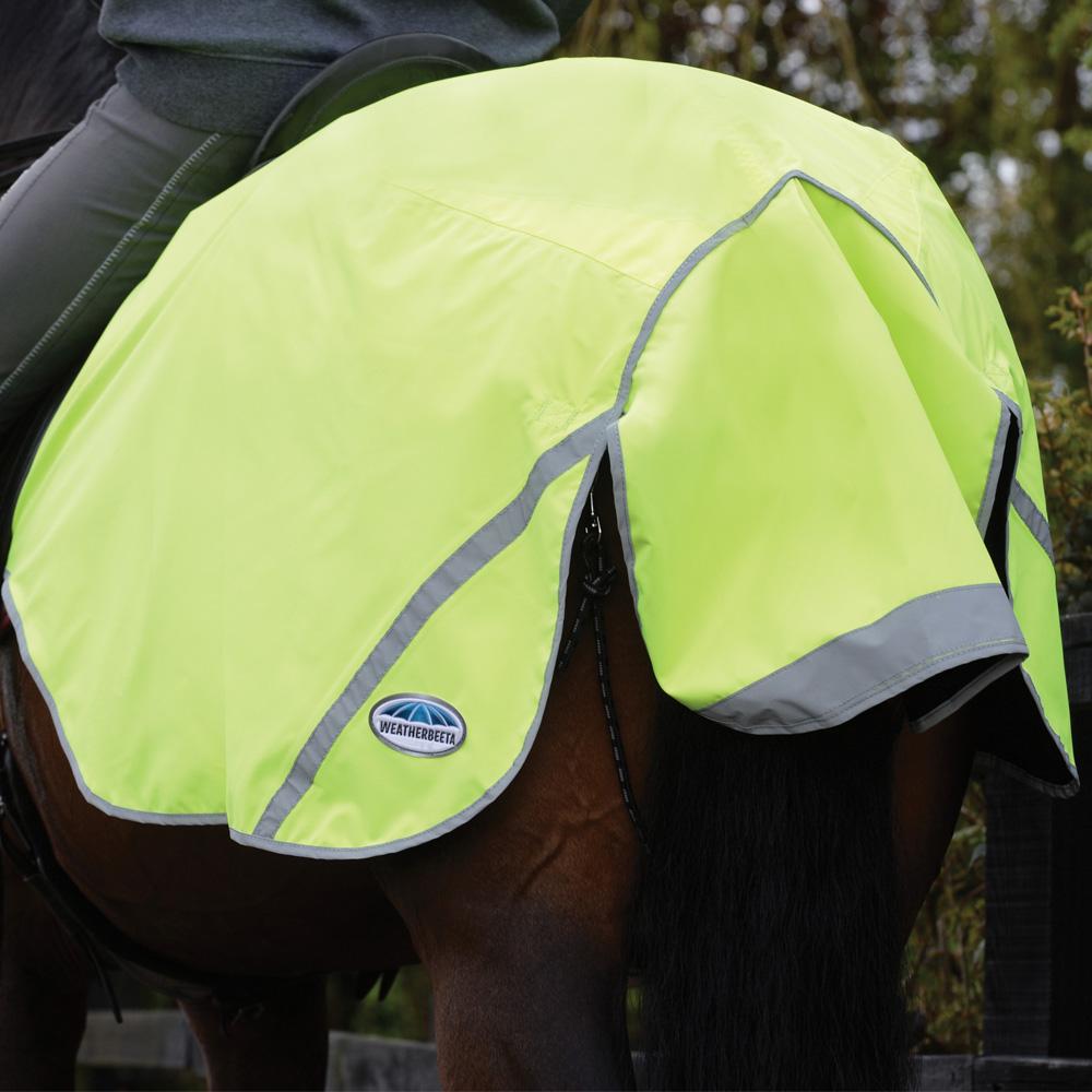Horse in a Weatherbeeta 300D Reflective Exercise Sheet, rider partially visible.