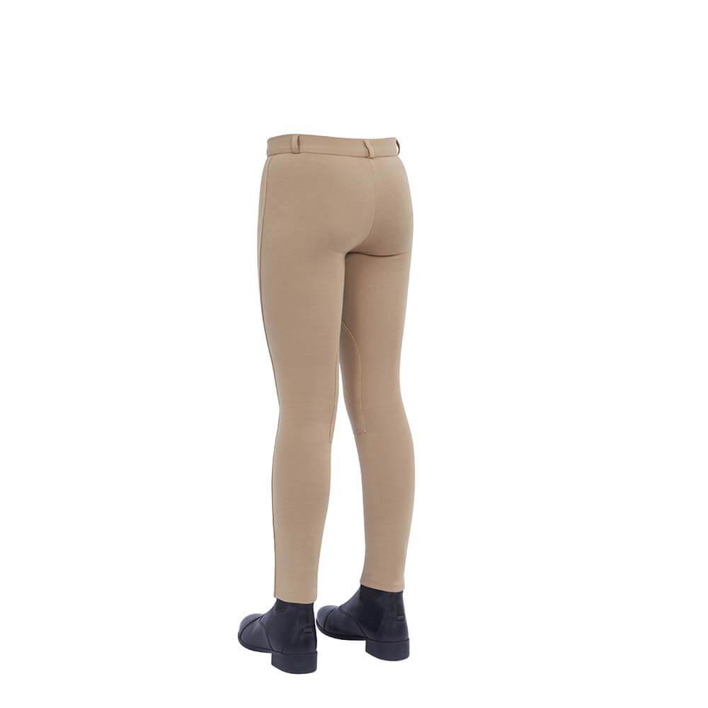 A child in Dublin Supa-Fit beige knee patch jodhpurs and black boots, seen from behind.