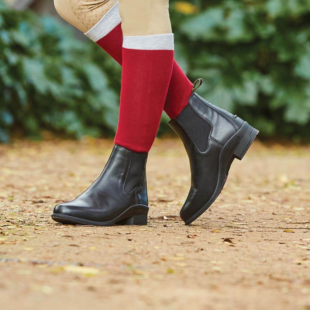 Person in Dublin Altitude Jodhpur Boot with durable rubber outsole, tan pants, and red socks.