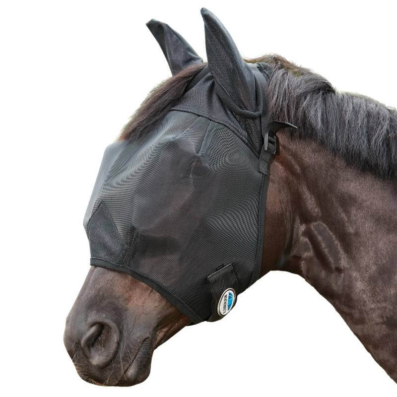 A horse wears the Weatherbeeta Comfitec Double Dart Deluxe Fly Mask With Ears, outside in greenery.