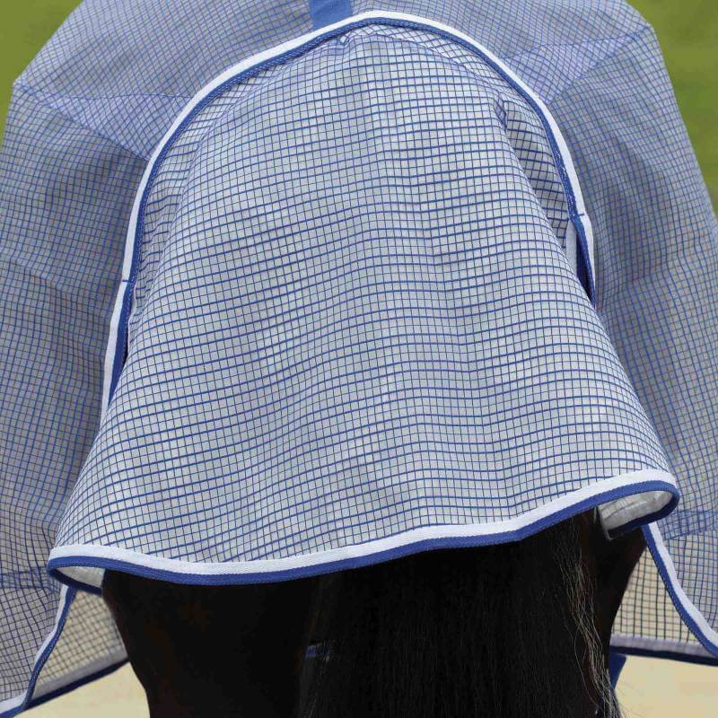 A horse wearing a Weatherbeeta Comfitec Ripshield Plus White/Blue rug for fly protection.