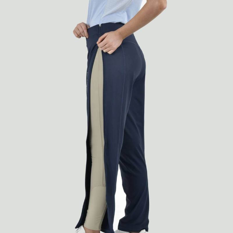 Person zipping up Weatherbeeta Dublin London Zip Off Trousers Ink Navy, wearing black boots.