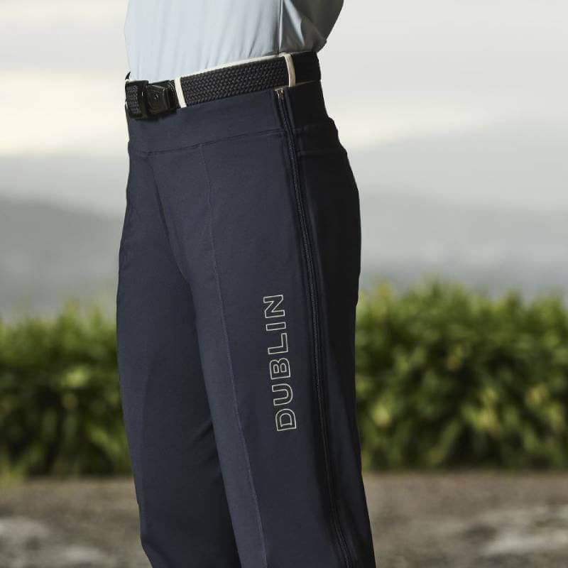 Person wearing Weatherbeeta Dublin London Zip Off Trousers Ink Navy, standing outdoors.