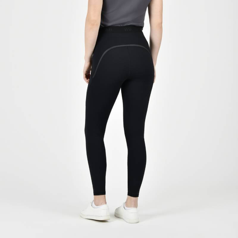 Wearing Weatherbeeta Toulon Lifestyle Tights Black and a grey shirt with white sneakers.