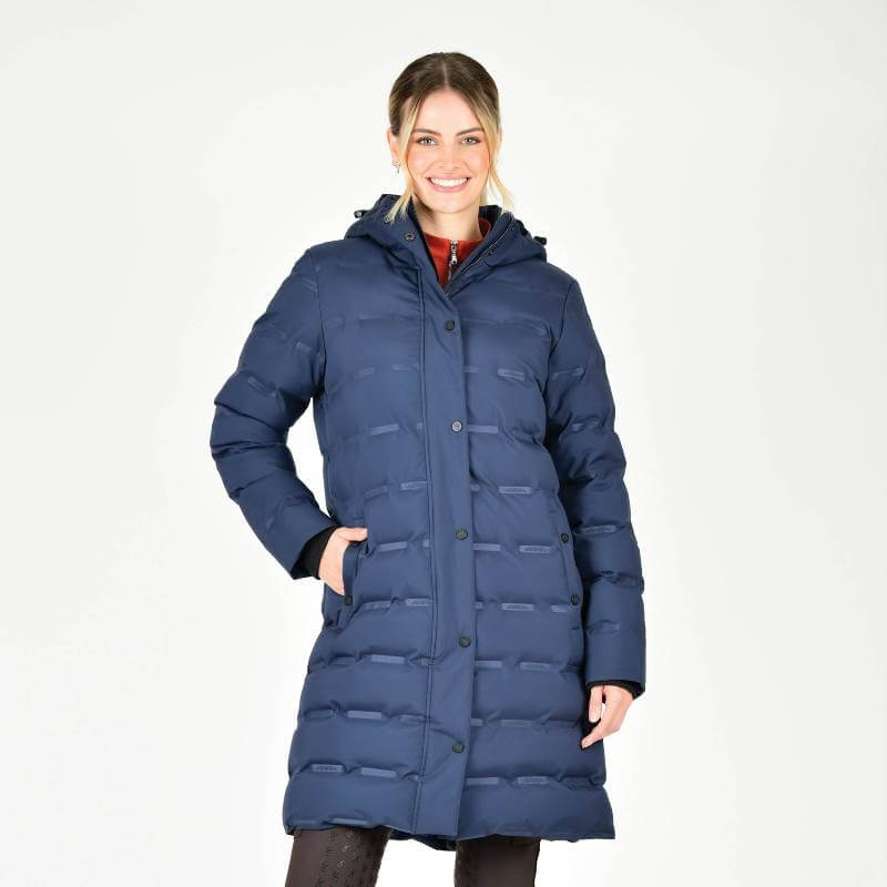 Smiling woman in Weatherbeeta Helsinki Heat Seal Quilted Jacket Navy Iris on white background.