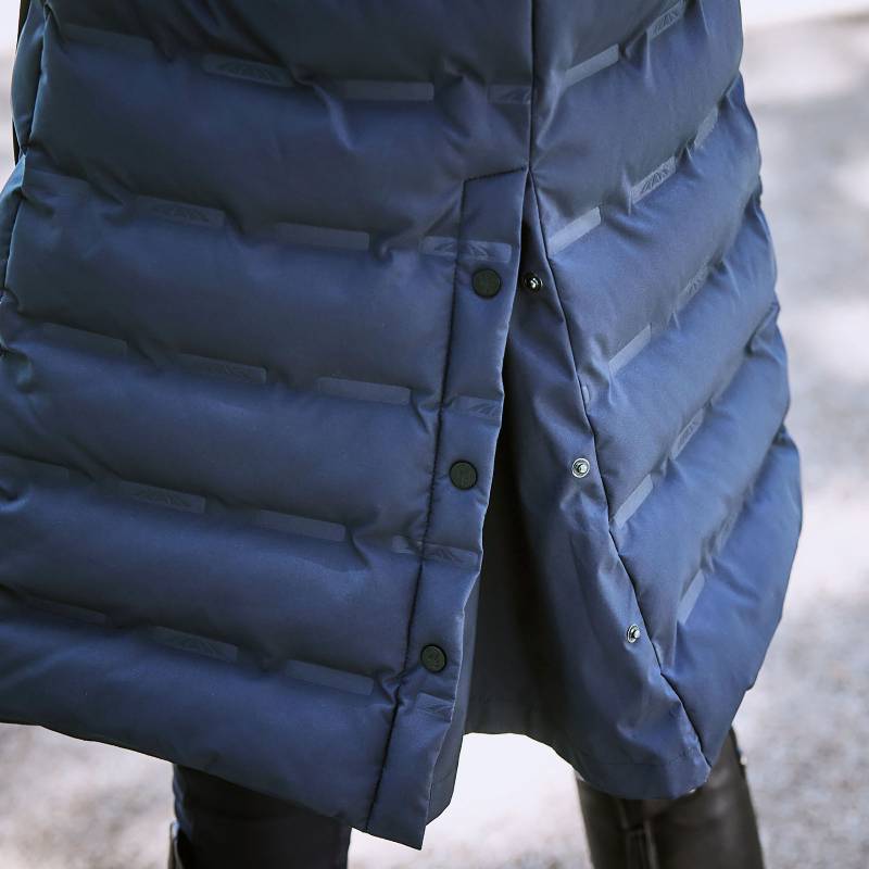 Close-up of the Weatherbeeta Helsinki Heat Seal Quilted Jacket Navy Iris, worn with dark pants.