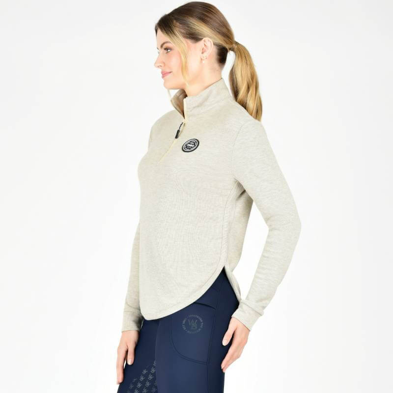 Woman in a Weatherbeeta London Layer Long Sleeve Top Irish Cream and dark pants, in profile.