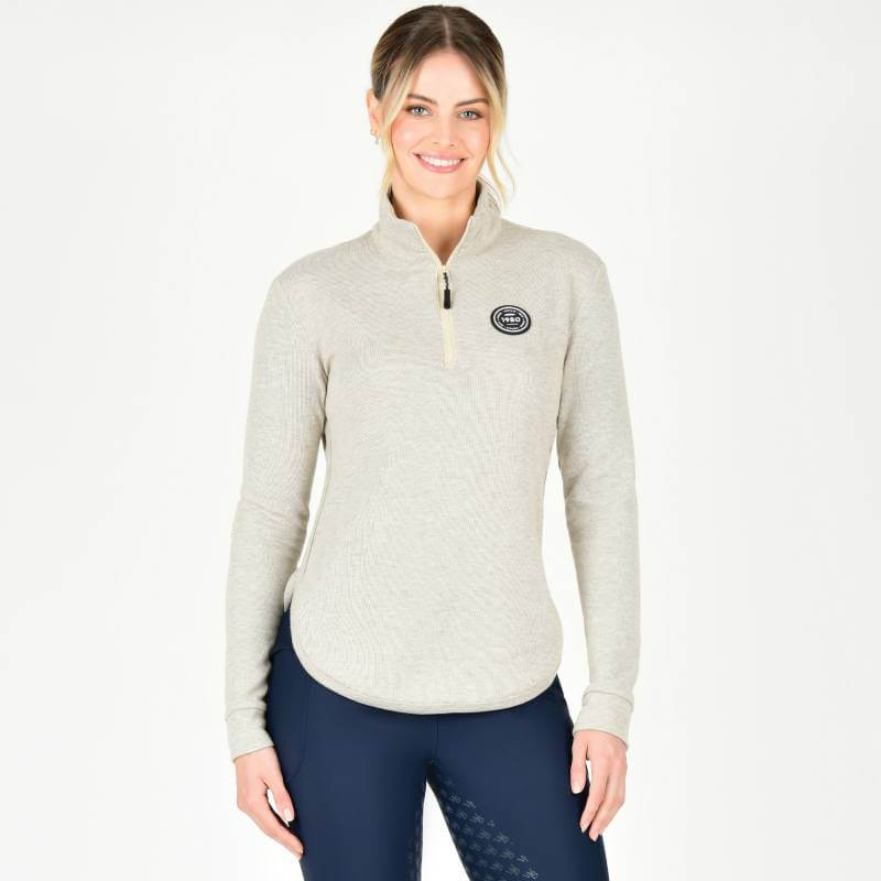 Woman in a Weatherbeeta London Layer Long Sleeve Top Irish Cream smiles against a white background.
