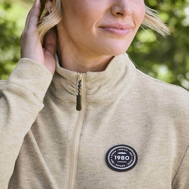 Woman in Weatherbeeta London Layer Long Sleeve Top Irish Cream, ideal for active outdoor wear.
