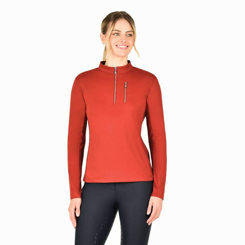 Smiling woman in Weatherbeeta Reno Long Sleeve Riding Top Red Ochre with UPF 50+ protection.