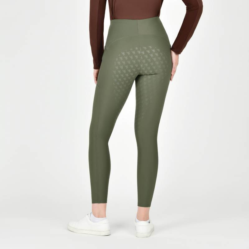 Person in Weatherbeeta Thermal Riding Tights Olive Night and a brown top, shown from the back.