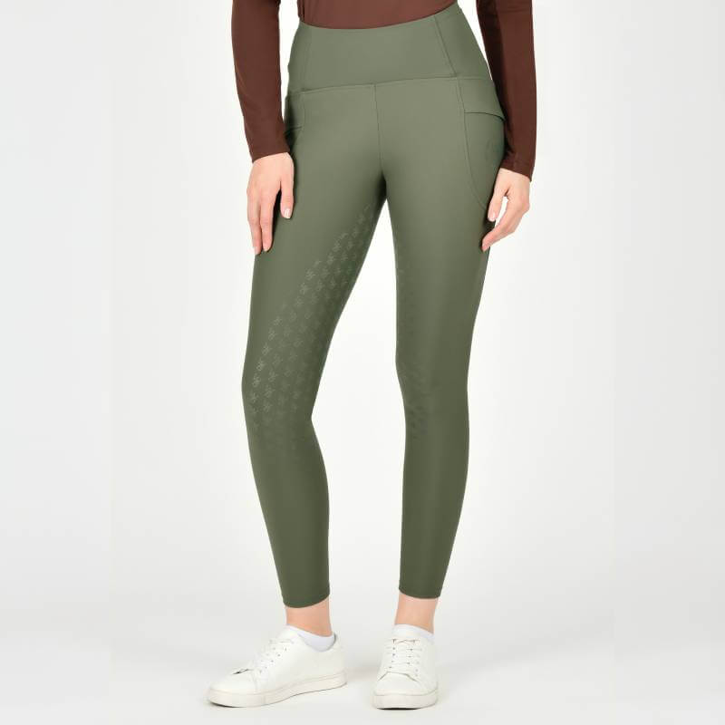 Wearing Weatherbeeta Thermal Riding Tights Olive Night, a brown top, and white sneakers.