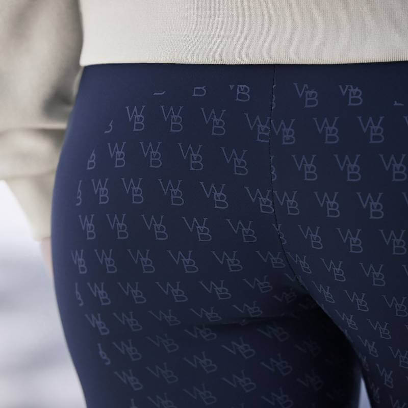 Woman in Weatherbeeta Thermal Riding Tights Sky Captain, with full seat gel grip and WB logo.