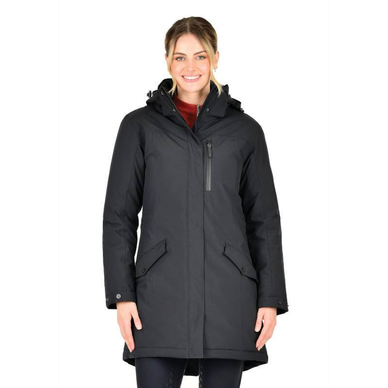 Smiling woman wearing a Weatherbeeta Kyla II Waterproof Jacket Black against a white background.