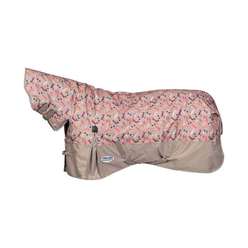 A horse in a Weatherbeeta ComFiTec Essential Dachshund Print blanket stands on green grass.