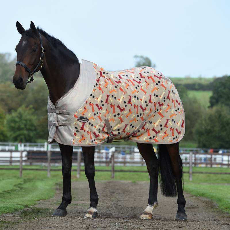 A dark brown horse wears a Weatherbeeta Fleece Cooler Standard Neck Dachshund Print outdoors.