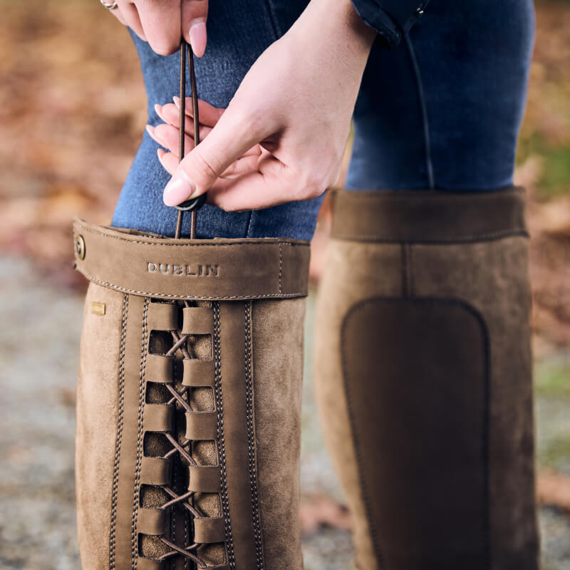 Hands adjusting laces on Dublin Pinnacle Boots III Chocolate with a memory foam footbed.
