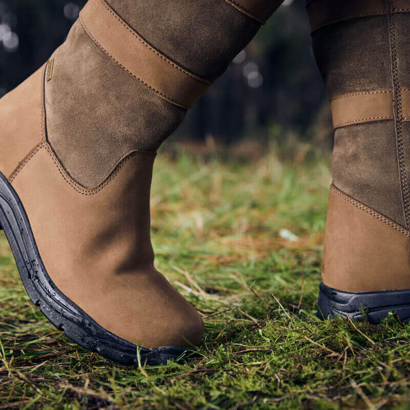 Dublin River Boots IV Dark Brown by Dublin shown on green mossy ground.