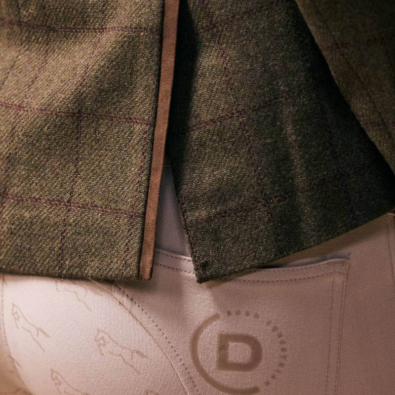 Dublin Albany tweed jacket with suede collar, paired with beige pants and circular pocket logo.