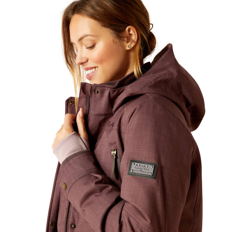 Woman in Ariat Womens Sterling Insulated H2O Parka Raisin, smiling and looking down left.